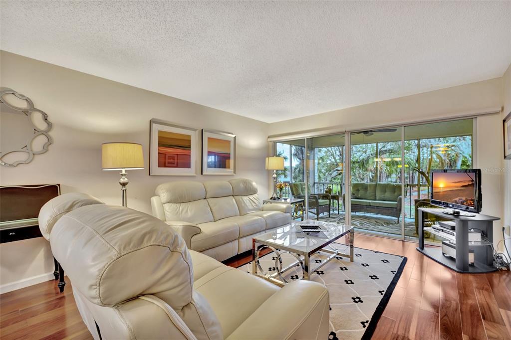 5248 Marsh Field Road, Unit 2 Sarasota, FL 34235 - Photo 7 of 30 a living room with furniture large window and wooden floor