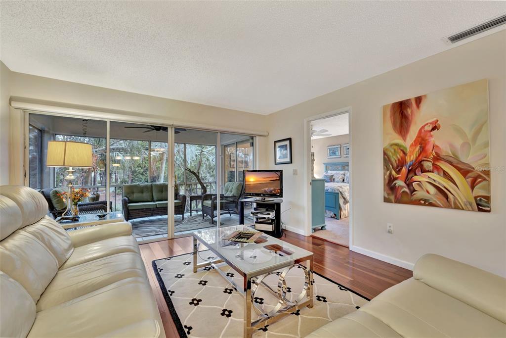 5248 Marsh Field Road, Unit 2 Sarasota, FL 34235 - Photo 8 of 30 a living room with furniture a large window and a flat screen tv