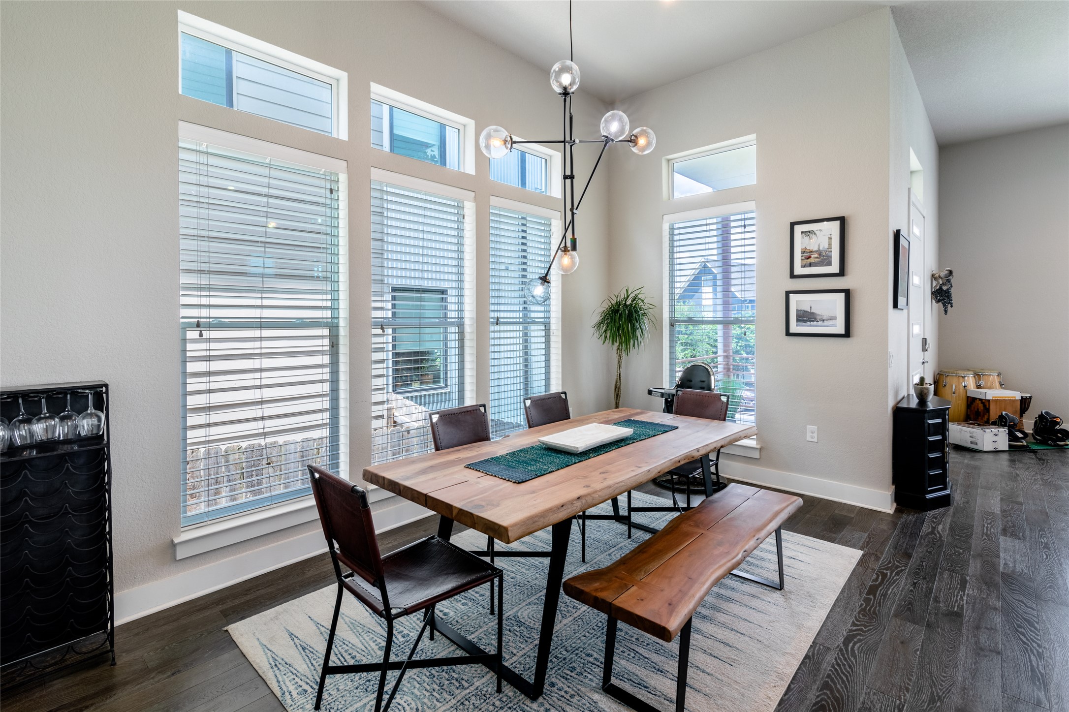 6025 Seville Drive Austin, TX 78724 - Photo 4 of 40 Spacious dinning room with high ceilings, featuring wood-finish flooring and multiple expansive windows with natural lighting.