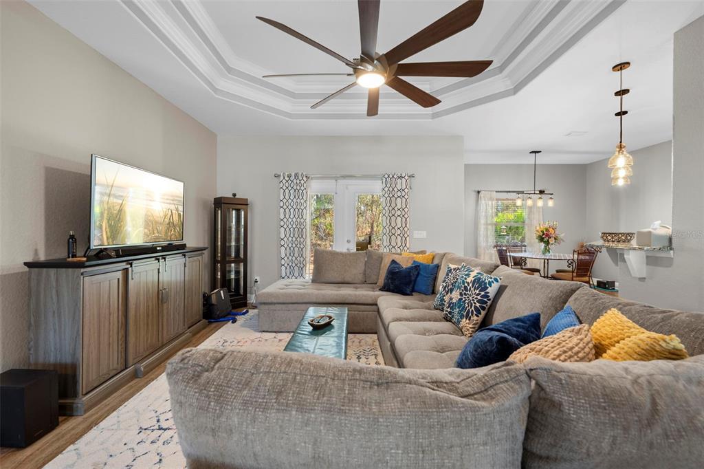 8104 Nightingale Road Weeki Wachee, FL 34613 - Photo 12 of 45 a living room with furniture and a flat screen tv