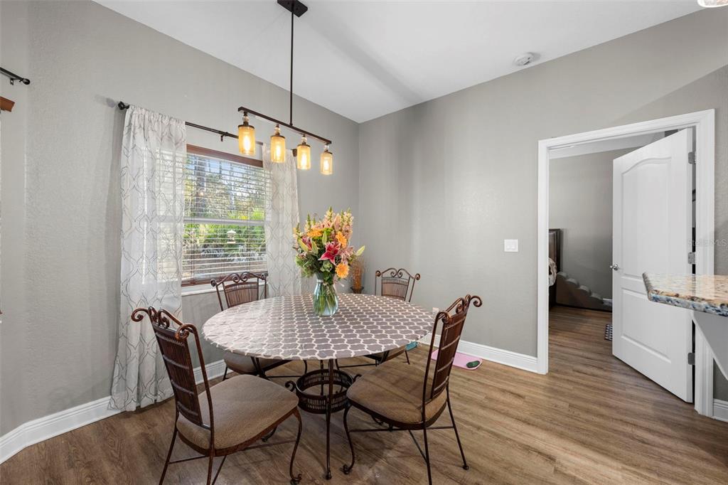 8104 Nightingale Road Weeki Wachee, FL 34613 - Photo 16 of 45 a view of a dining room with furniture window and wooden floor