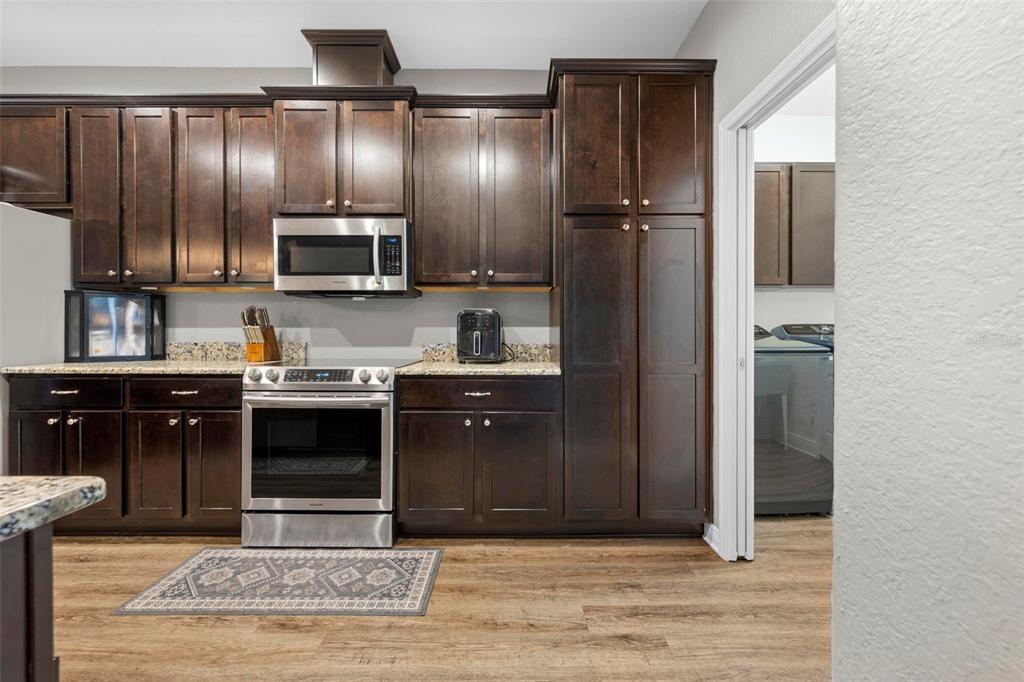 8104 Nightingale Road Weeki Wachee, FL 34613 - Photo 22 of 45 a kitchen with a refrigerator and a stove