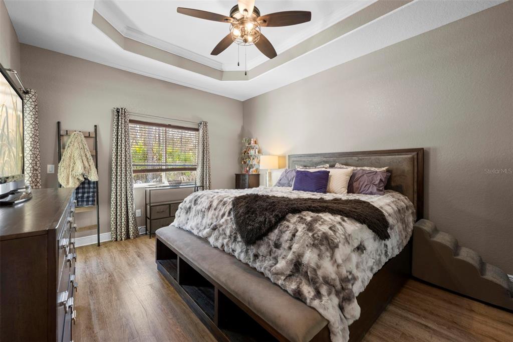 8104 Nightingale Road Weeki Wachee, FL 34613 - Photo 28 of 45 a bedroom with a large bed and a chandelier