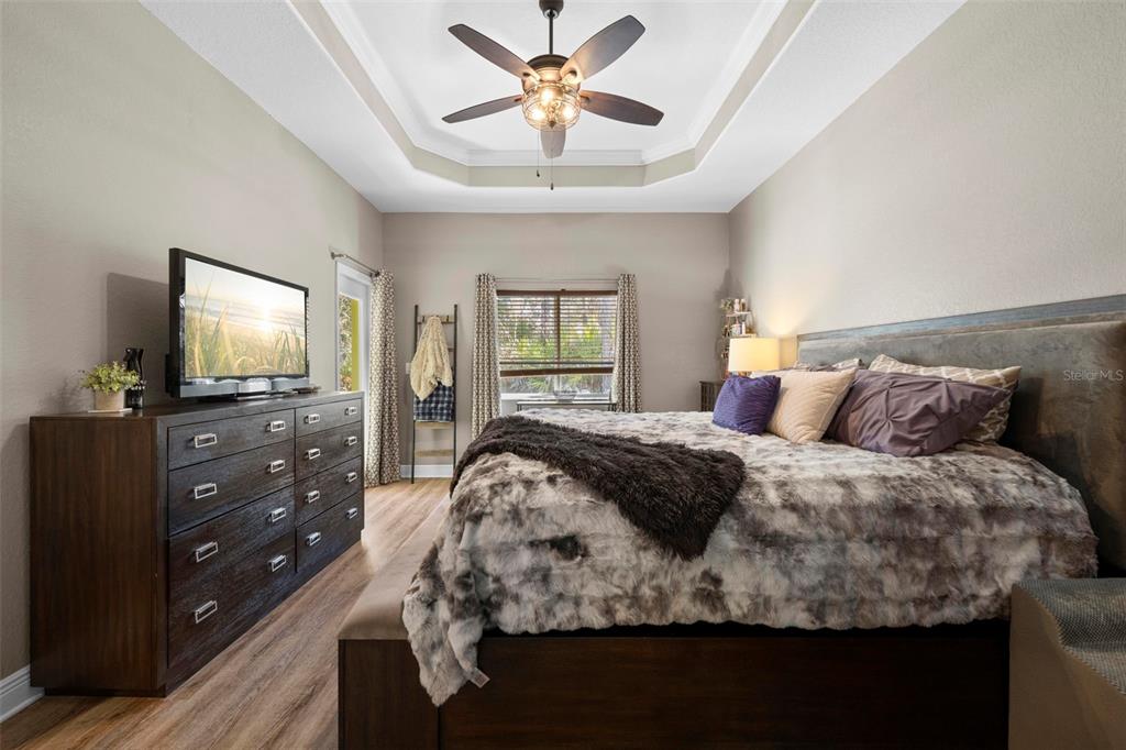 8104 Nightingale Road Weeki Wachee, FL 34613 - Photo 29 of 45 a bedroom with a bed and a flat tv screen on dresser