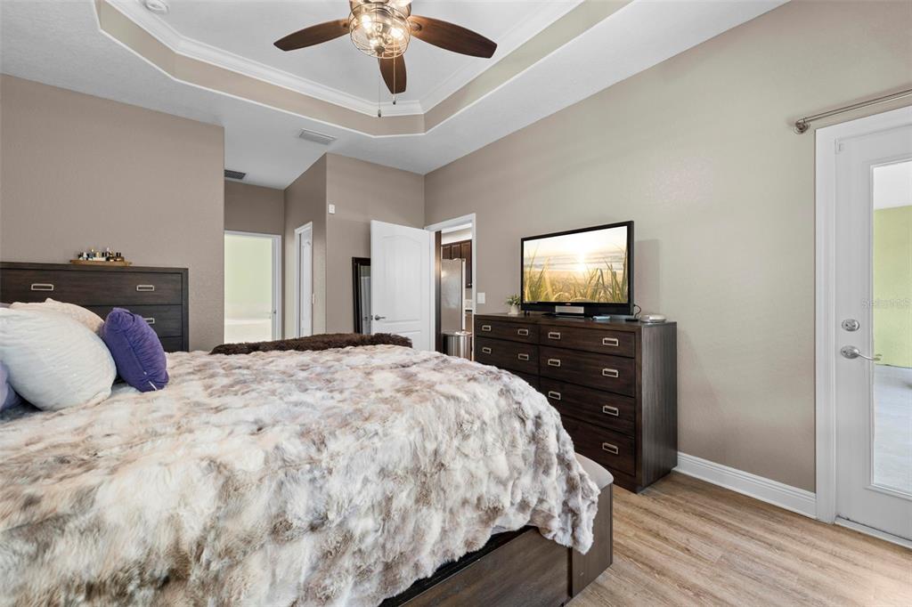 8104 Nightingale Road Weeki Wachee, FL 34613 - Photo 30 of 45 a bedroom with a bed and a flat tv screen on dresser