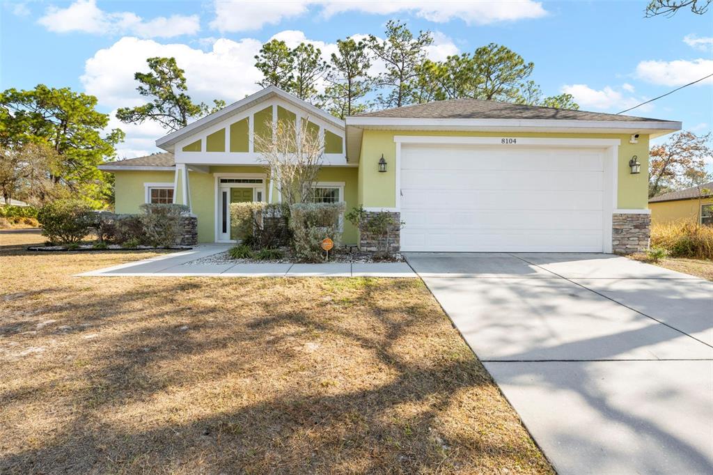 8104 Nightingale Road Weeki Wachee, FL 34613 - Photo 35 of 45 a front view of a house with a yard