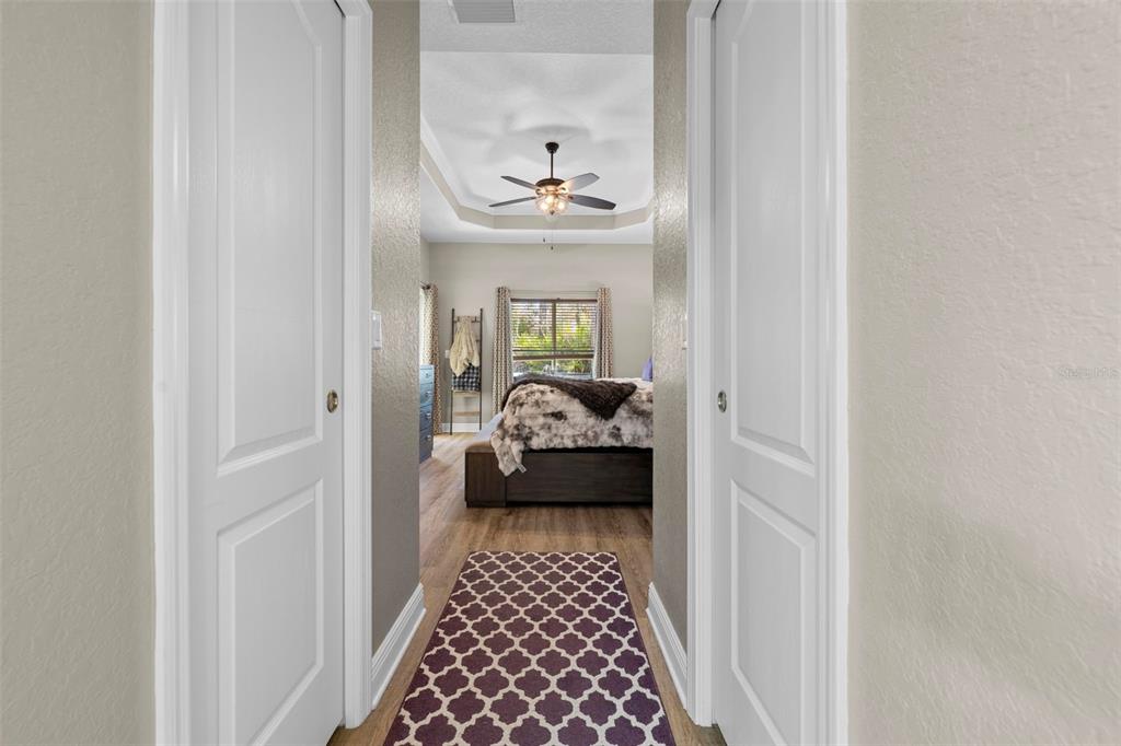 8104 Nightingale Road Weeki Wachee, FL 34613 - Photo 36 of 45 a view of a hallway with wooden floor and a livingroom