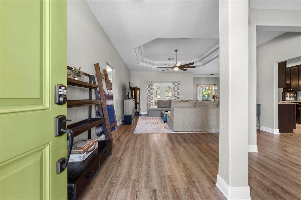 8104 Nightingale Road Weeki Wachee, FL 34613 - Photo 5 of 45 a view of a hallway with wooden floor and staircase