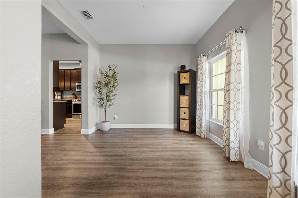 8104 Nightingale Road Weeki Wachee, FL 34613 - Photo 7 of 45 a view of an empty room with window and wooden floor