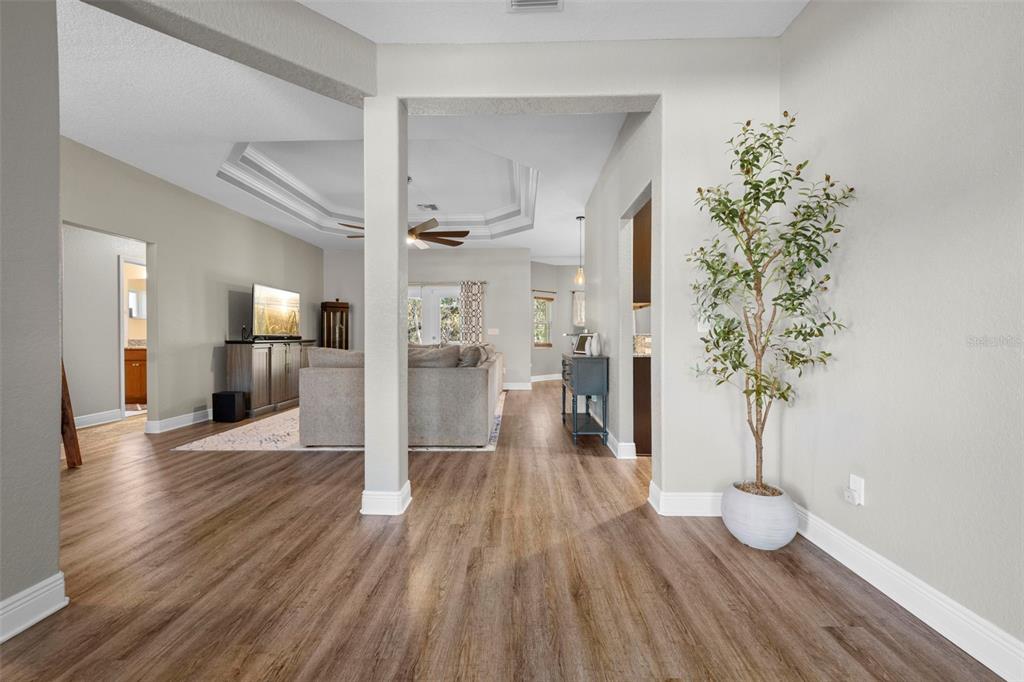 8104 Nightingale Road Weeki Wachee, FL 34613 - Photo 9 of 45 a view of a hallway view with wooden floor and a potted plant