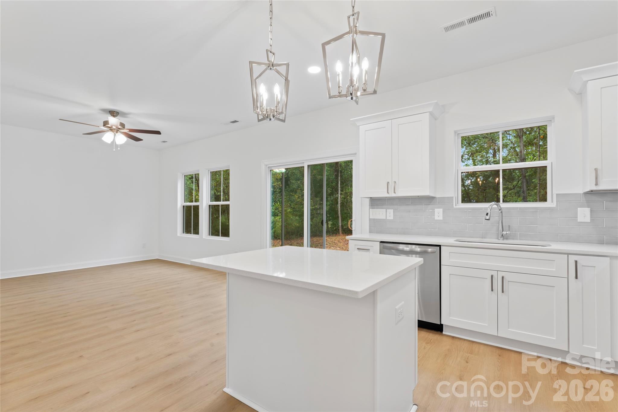 192 Doolie Road Mooresville, NC 28117 - Photo 19 of 36 a large kitchen with kitchen island white cabinets and chandelier