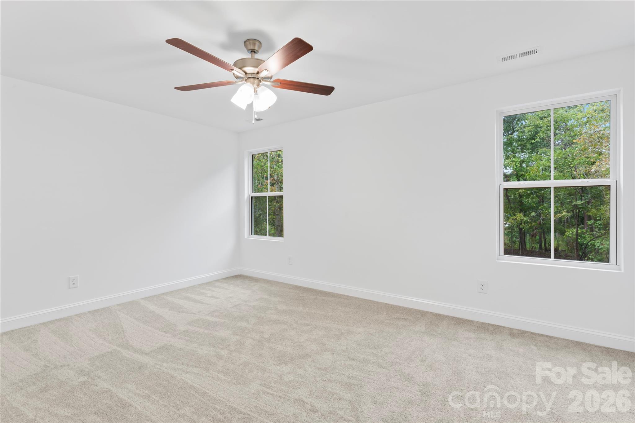 192 Doolie Road Mooresville, NC 28117 - Photo 21 of 36 an empty room with a window and a fan