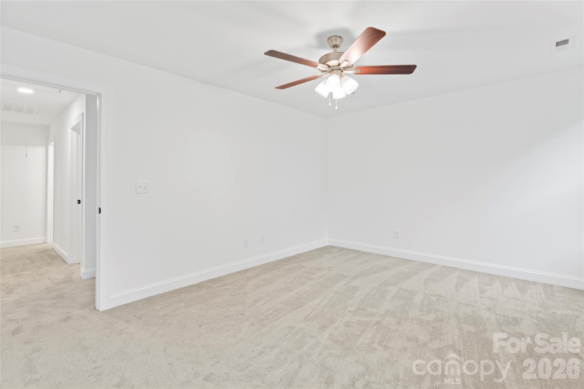 192 Doolie Road Mooresville, NC 28117 - Photo 24 of 36 an empty room with a chandelier fan and closet area