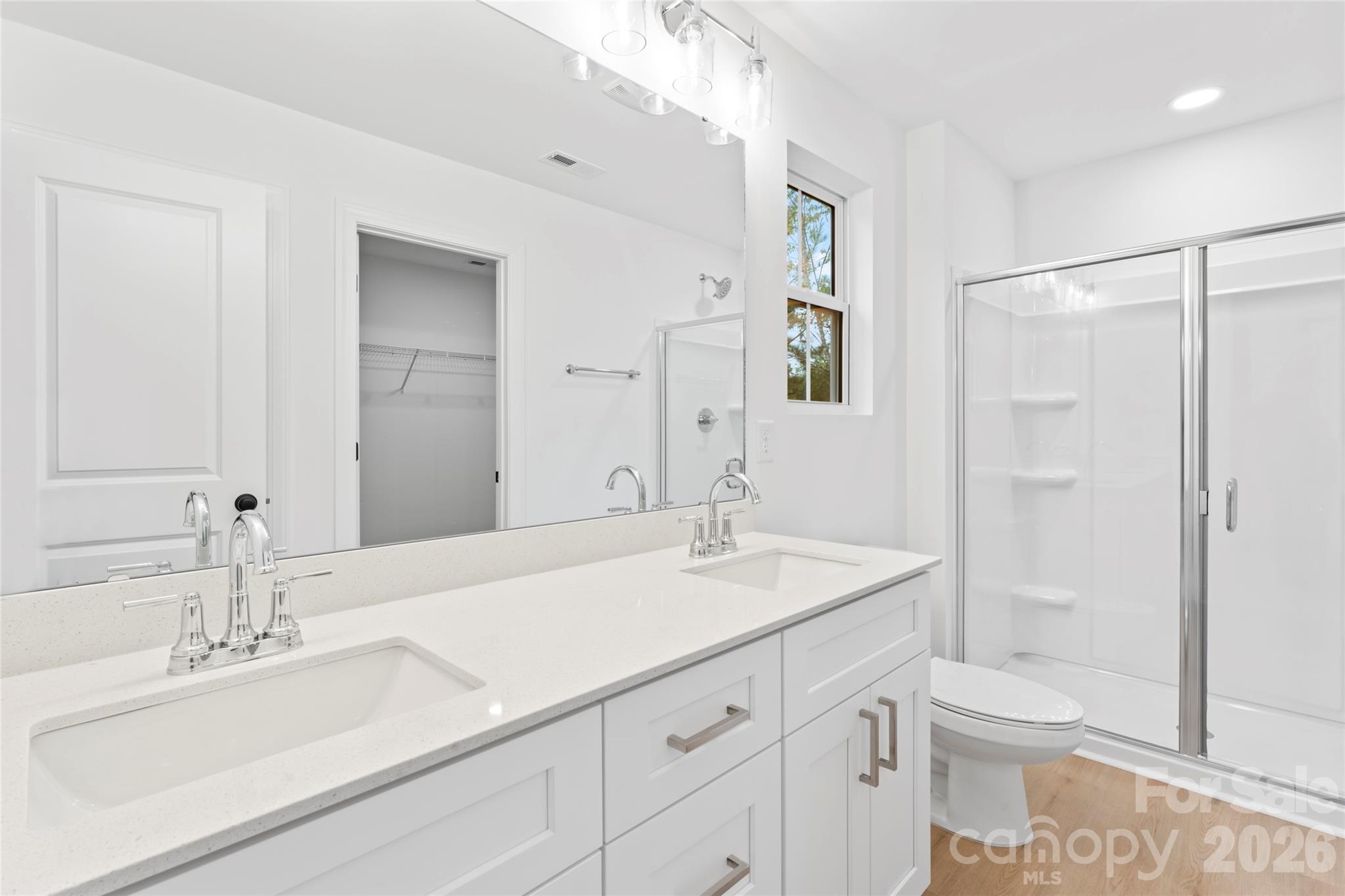 192 Doolie Road Mooresville, NC 28117 - Photo 25 of 36 a bathroom with a sink toilet double vanity and shower