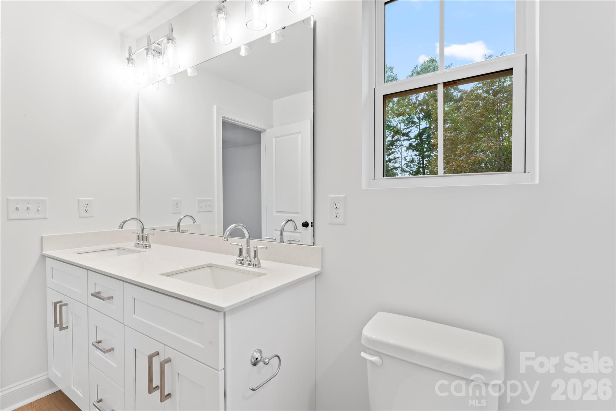 192 Doolie Road Mooresville, NC 28117 - Photo 26 of 36 a bathroom with a toilet sink and mirror