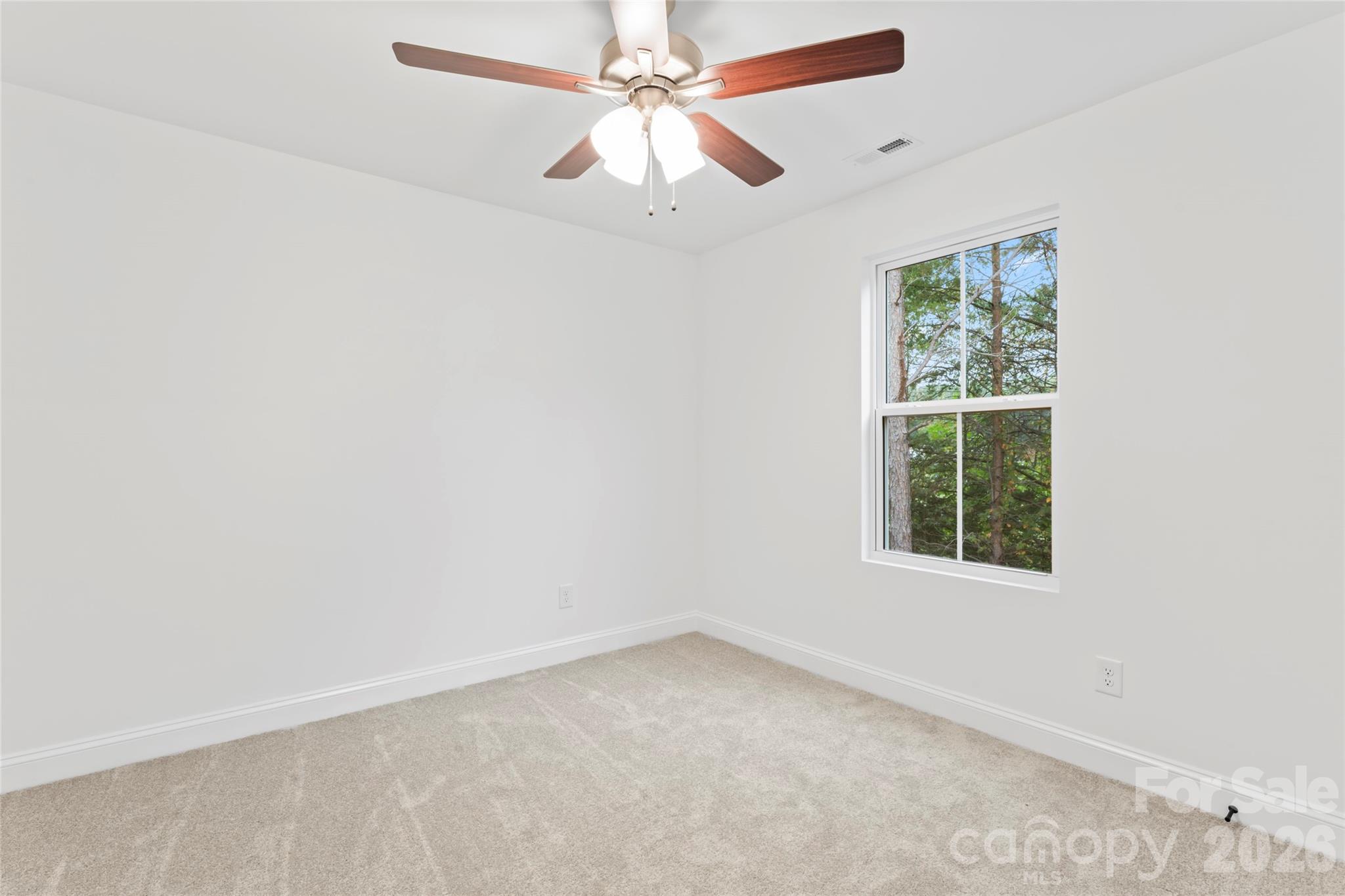 192 Doolie Road Mooresville, NC 28117 - Photo 34 of 36 an empty room with a window and a fan