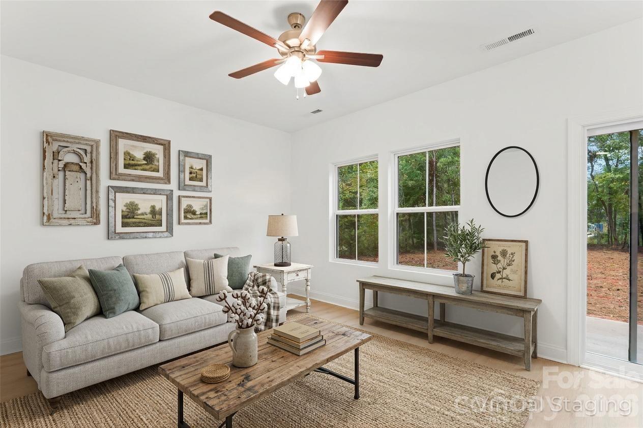 192 Doolie Road Mooresville, NC 28117 - Photo 4 of 36 a living room with furniture a window and a potted plant