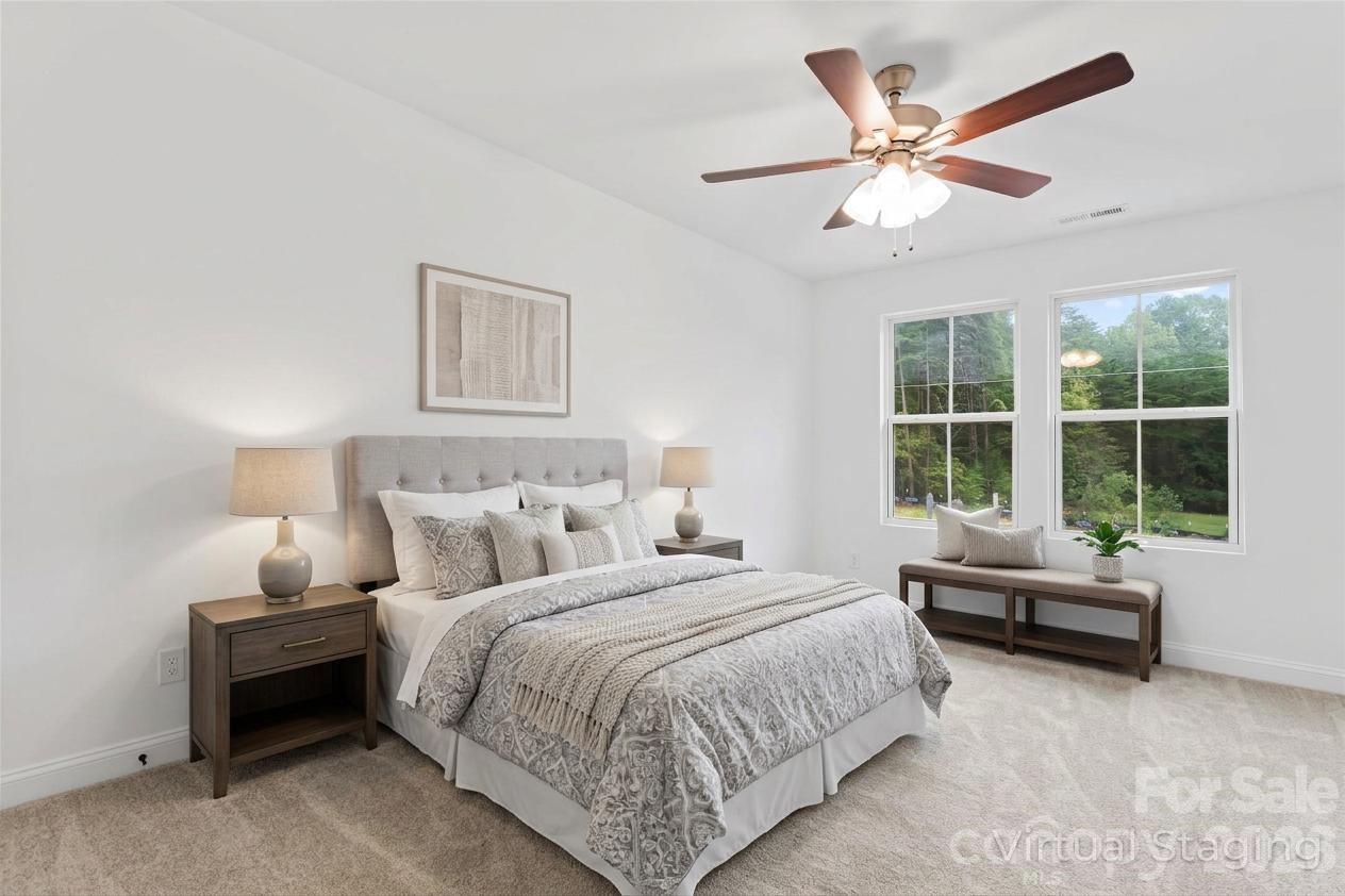 192 Doolie Road Mooresville, NC 28117 - Photo 5 of 36 a bedroom with a bed and a large window