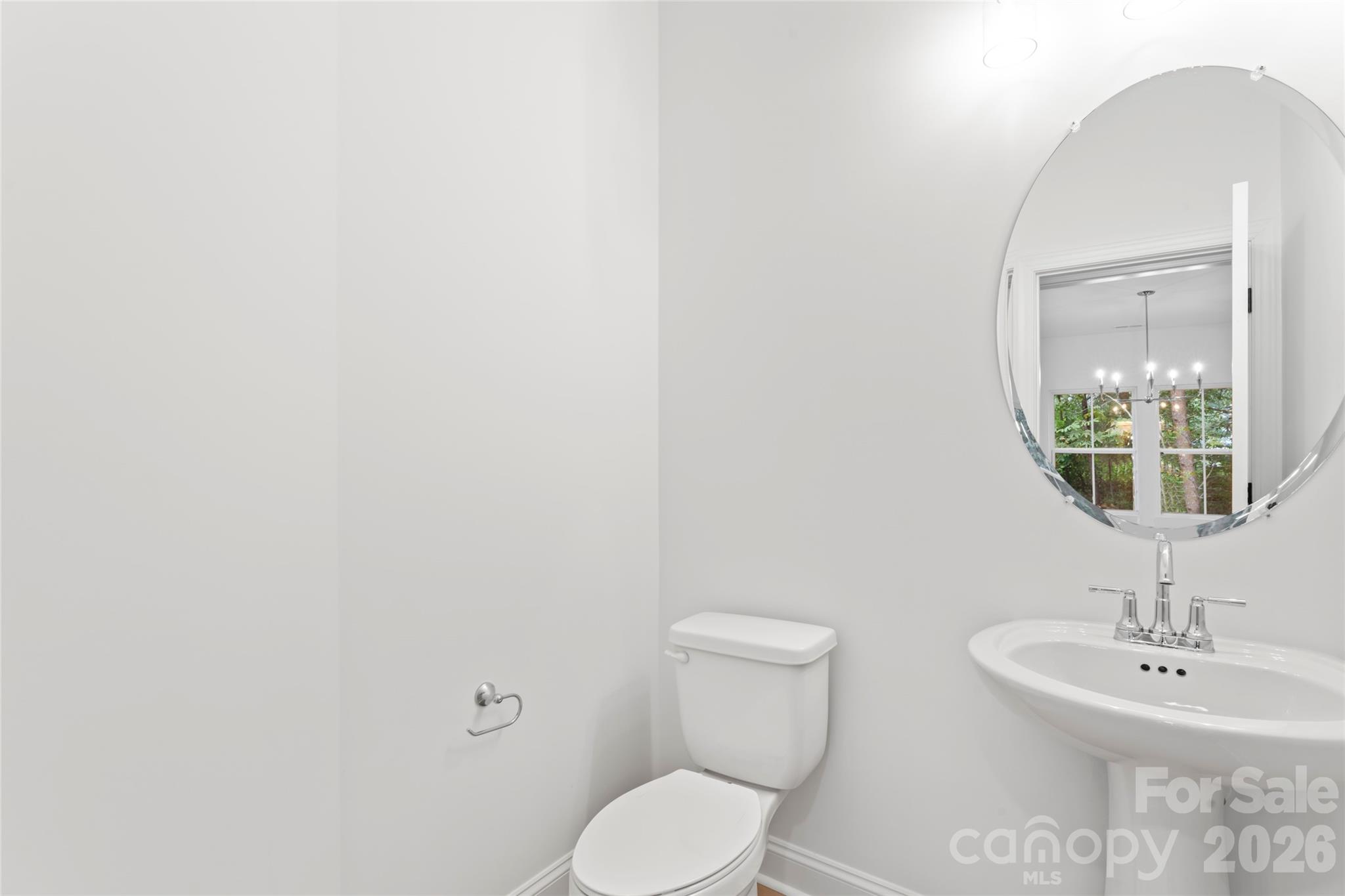 192 Doolie Road Mooresville, NC 28117 - Photo 7 of 36 a bathroom with a toilet a sink and mirror