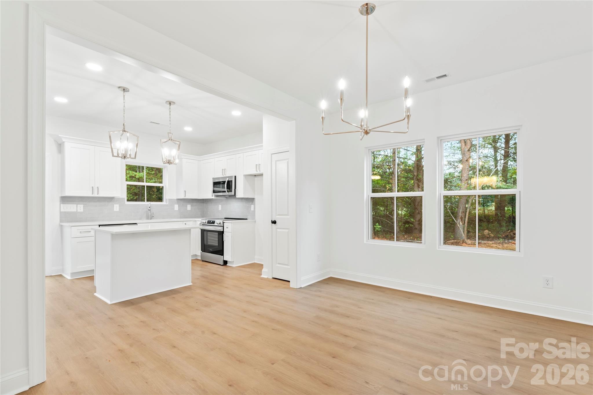 192 Doolie Road Mooresville, NC 28117 - Photo 8 of 36 a view of a kitchen with kitchen island a counter top space stainless steel appliances and a window