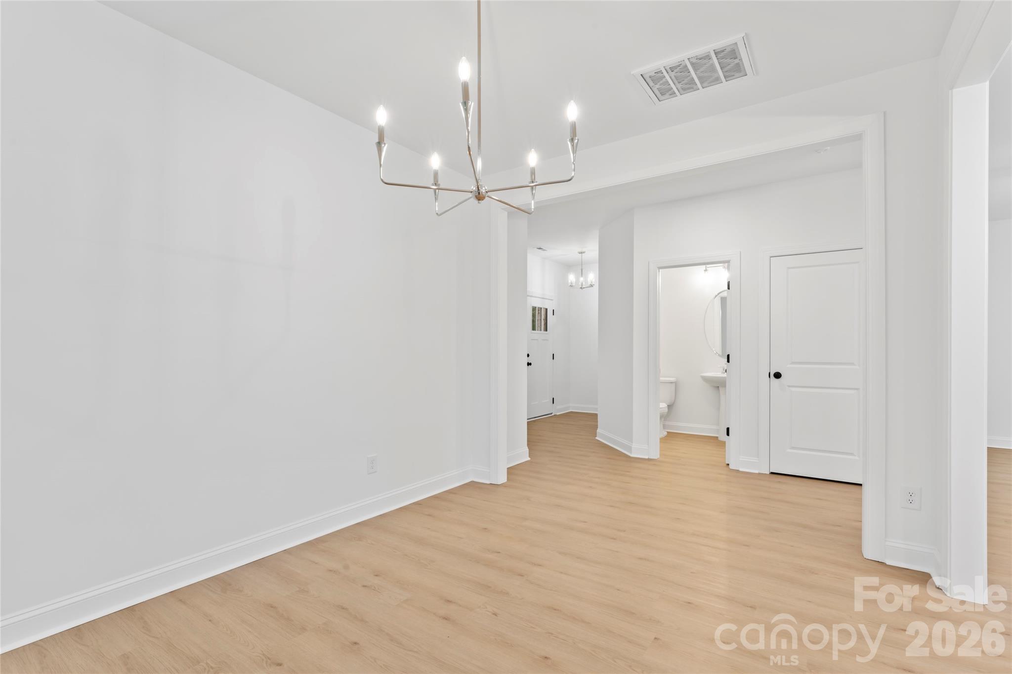 192 Doolie Road Mooresville, NC 28117 - Photo 10 of 36 wooden floor in an empty room with a bathroom
