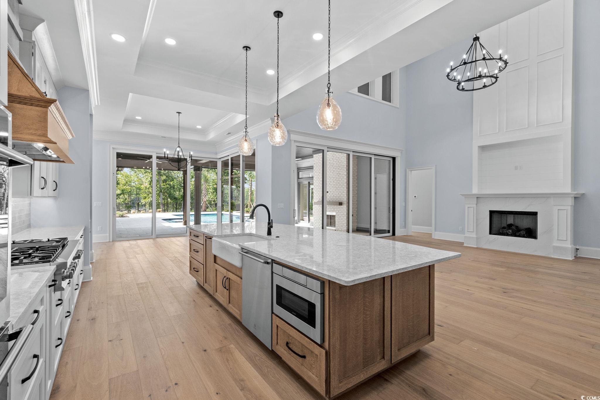 372 Chamberlin Road Myrtle Beach, SC 29588 - Photo 13 of 39 Kitchen with a chandelier, crown molding, stainles