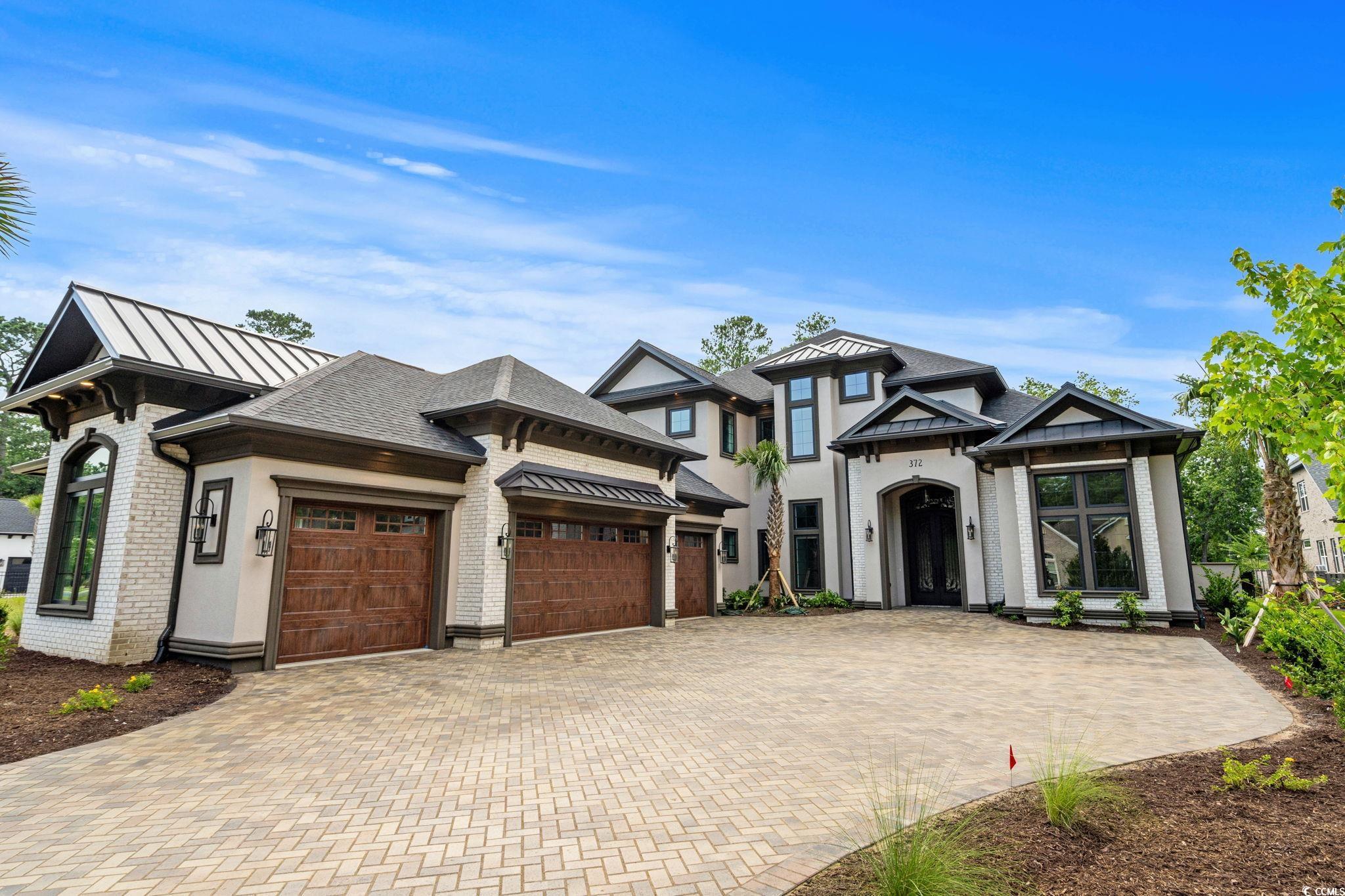 372 Chamberlin Road Myrtle Beach, SC 29588 - Photo 2 of 39 View of front of house with a garage, decorative d