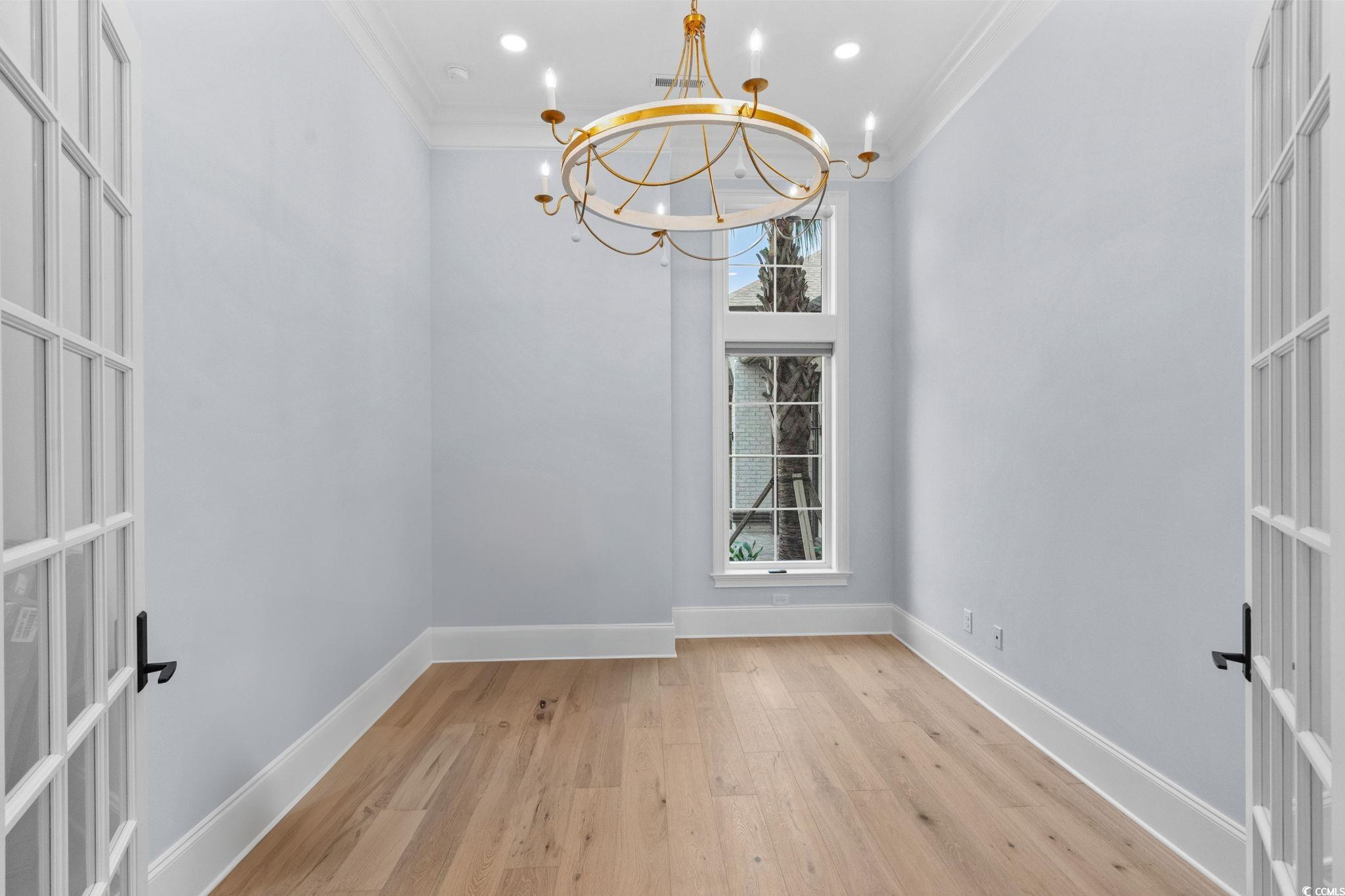 372 Chamberlin Road Myrtle Beach, SC 29588 - Photo 22 of 39 Unfurnished dining area with a chandelier, crown m
