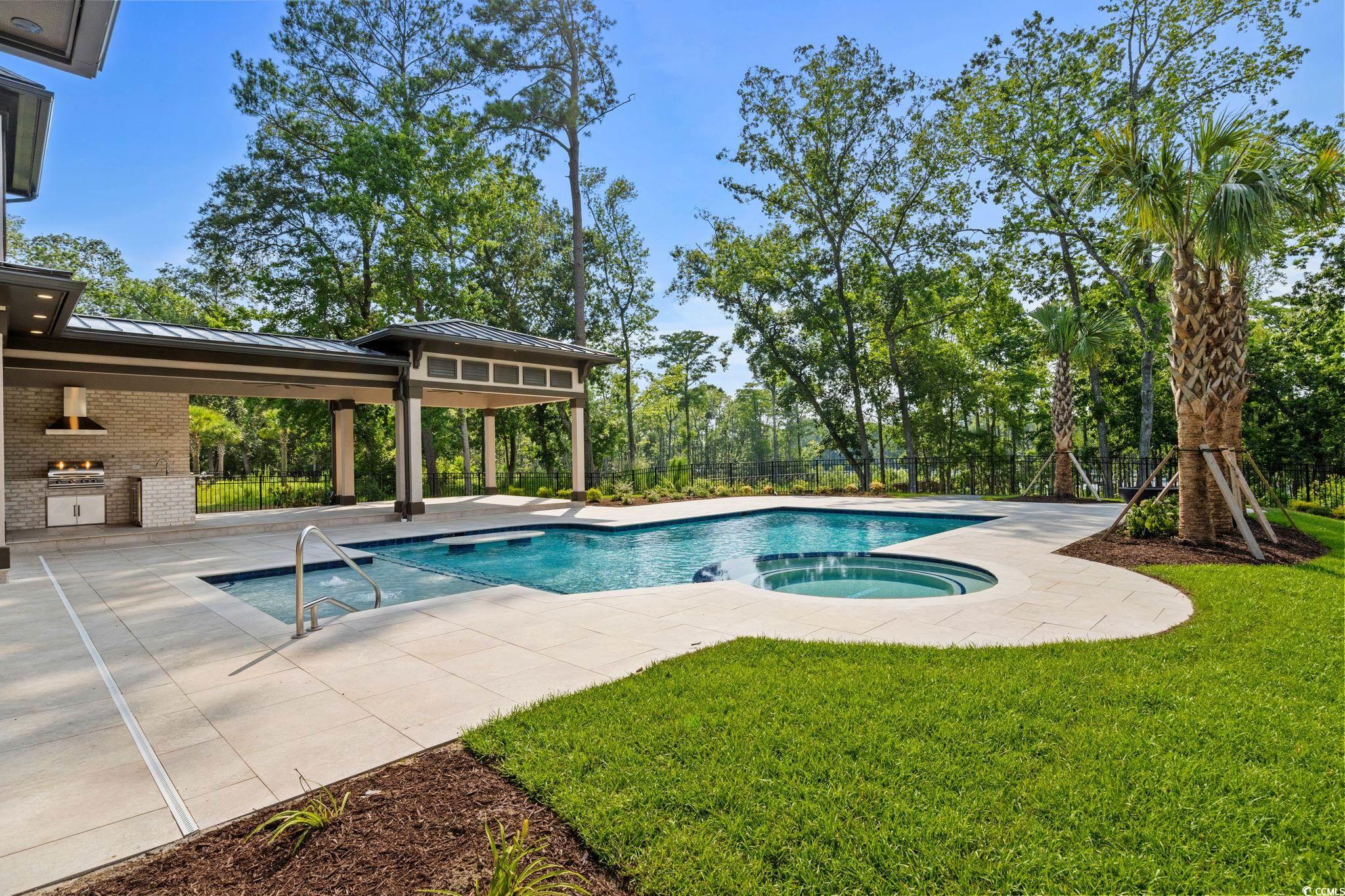 372 Chamberlin Road Myrtle Beach, SC 29588 - Photo 34 of 39 View of pool featuring exterior kitchen, a patio,