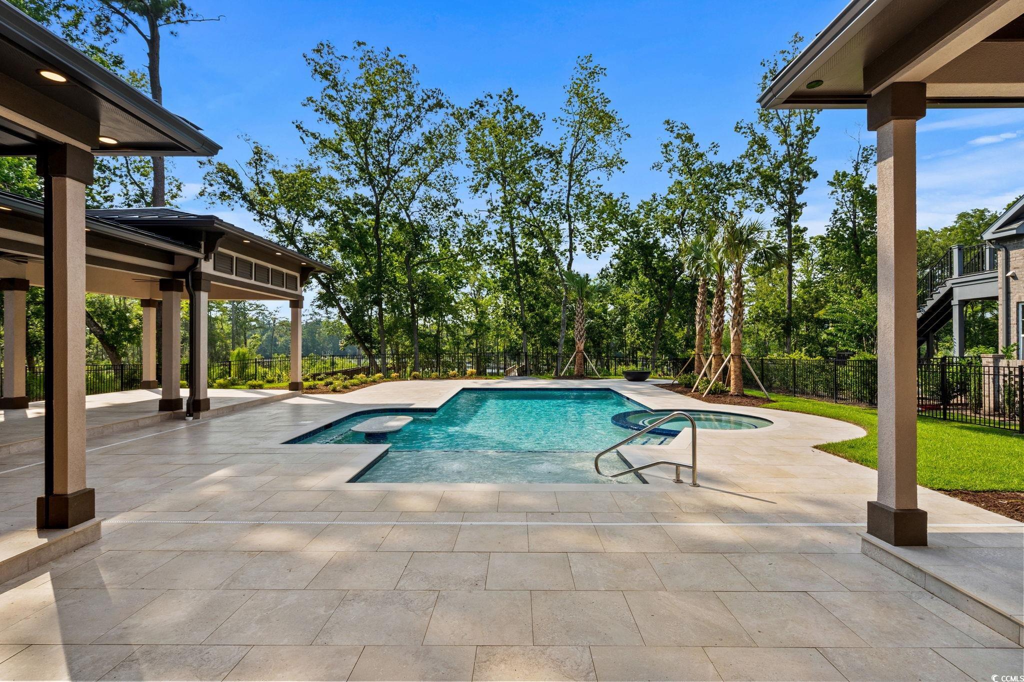 372 Chamberlin Road Myrtle Beach, SC 29588 - Photo 39 of 39 View of swimming pool featuring a patio area, a fe