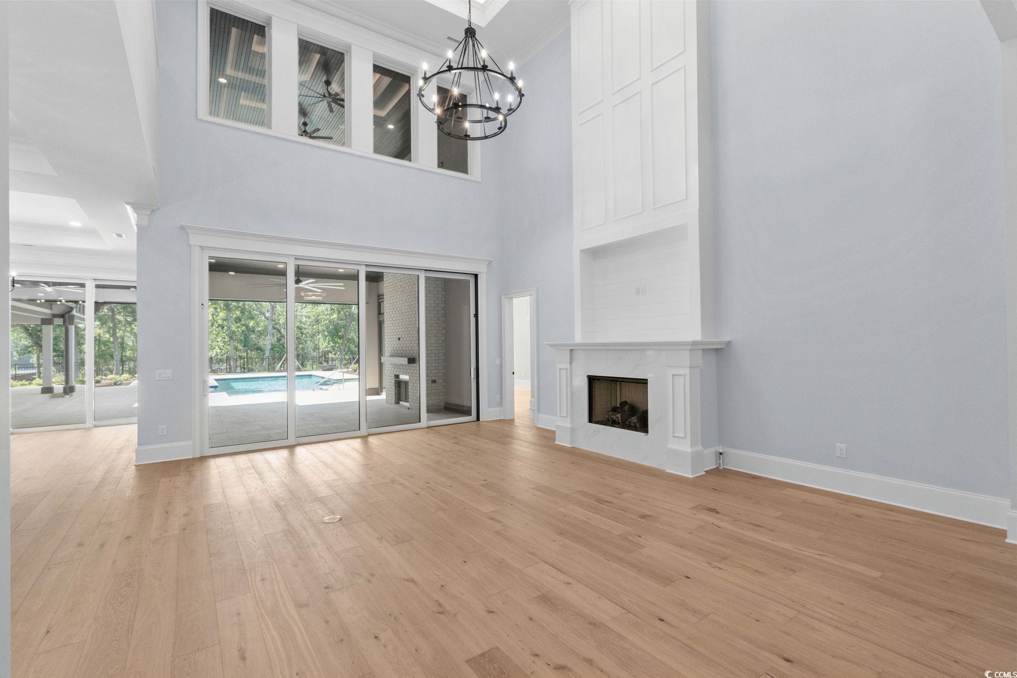 372 Chamberlin Road Myrtle Beach, SC 29588 - Photo 8 of 39 Unfurnished living room featuring light wood-style