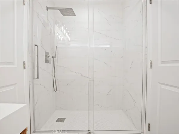 a bathroom with a glass shower door