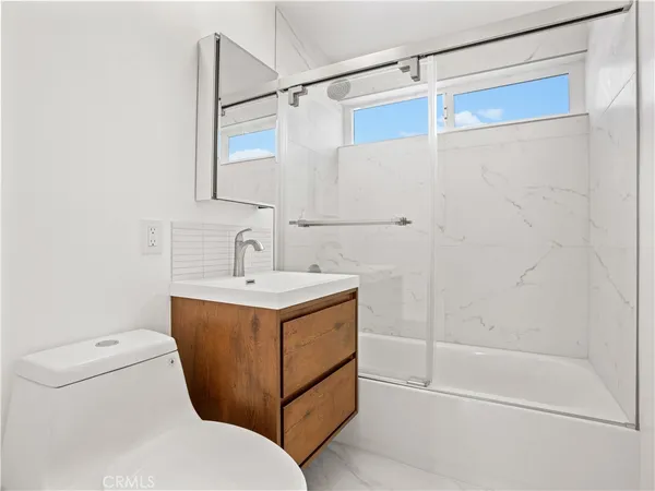a bathroom with a sink a mirror and a shower