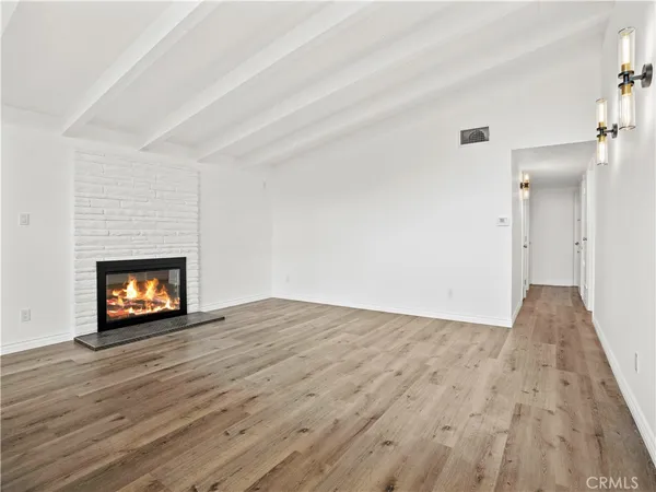 a view of an empty room and fire place