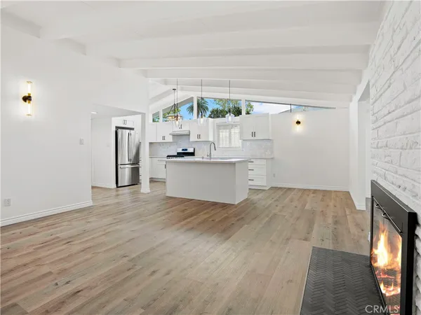 a view of a kitchen with a sink cabinets and a fireplace