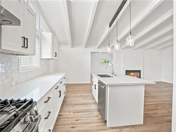 a kitchen with white cabinets and white appliances