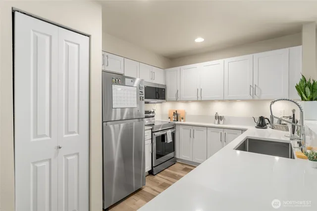 a kitchen with a sink a stove and refrigerator