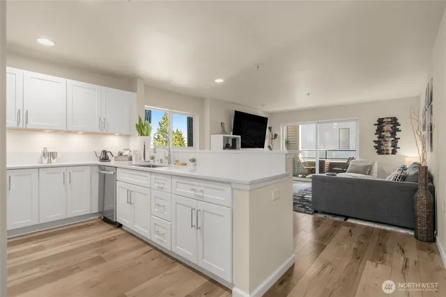 a kitchen with granite countertop a sink and a stove top oven
