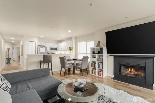 a living room with furniture a flat screen tv and a fireplace