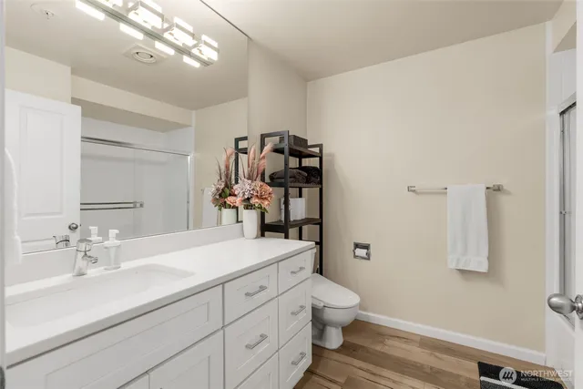 a bathroom with a sink a toilet and mirror