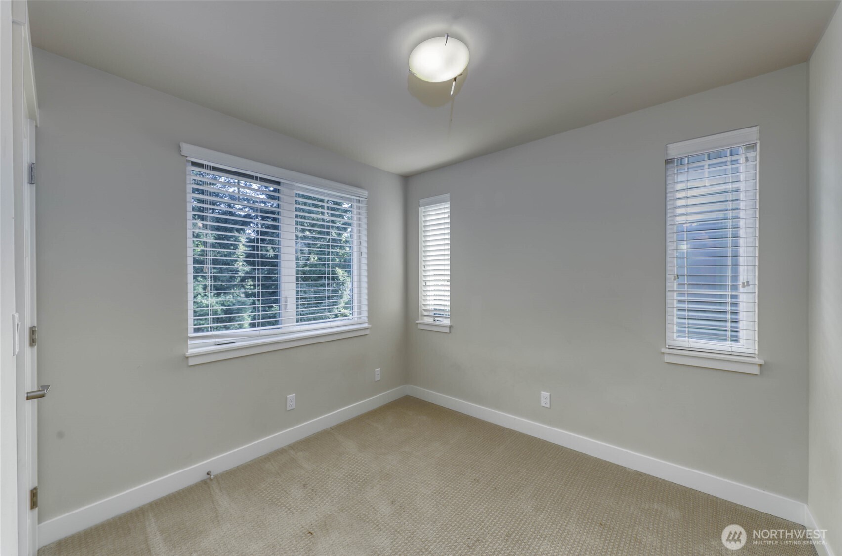690 Wintersweet Road Northeast Bainbridge Island, WA 98110 - Photo 17 of 23 an empty room with a window