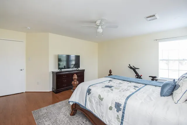 a bedroom with a bed and a flat screen tv