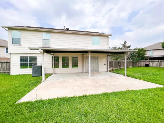 a view of a house with a yard and sitting area