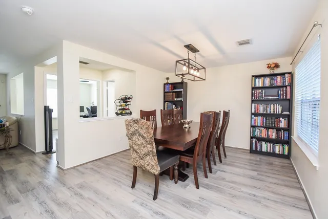 a view of a dining room with furniture and wooden floor