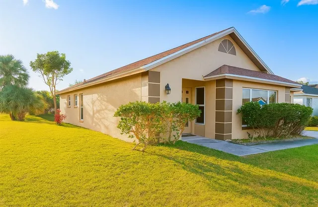 a front view of house with yard and swimming pool
