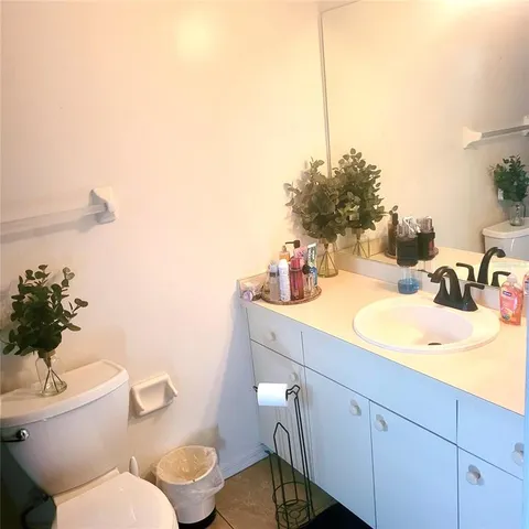 a bathroom with a sink mirror vanity and toilet