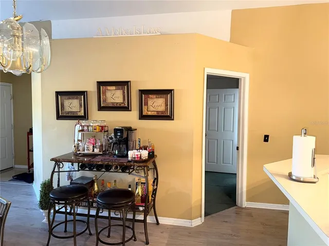a view of a dining room with furniture and chandelier