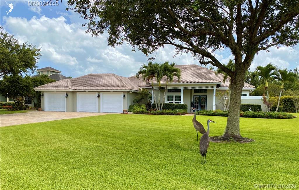 2198 Southwest Mainsail Terrace Stuart, FL 34997 - Photo 1 of 68 a front view of a house with a yard table and chairs