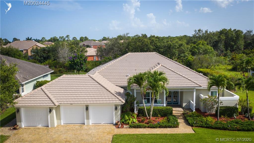 2198 Southwest Mainsail Terrace Stuart, FL 34997 - Photo 2 of 68 a front view of a house with a yard