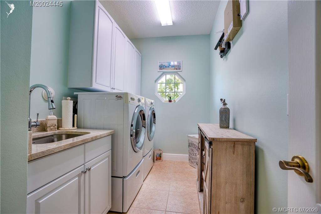 2198 Southwest Mainsail Terrace Stuart, FL 34997 - Photo 21 of 68 a kitchen with stainless steel appliances granite countertop a sink stove and refrigerator